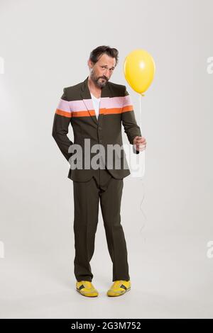 Happy man with yellow balloon Stock Photo