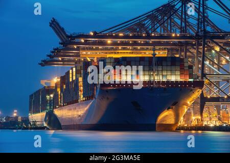 A night view of Ultra Large container ships loading at the Trinity terminal at the Port of Felixstowe - June 2017 Stock Photo