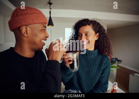 African American couple drinking coffee. Mixed race couple looking at each other in the kitchen at home. High quality photo Stock Photo