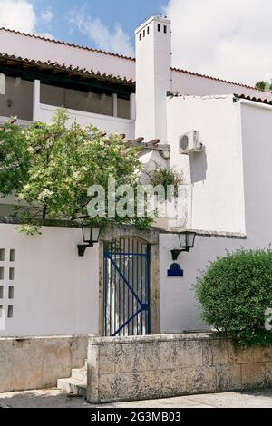 Closed lattice gate in a brick fence in front of the house Stock Photo