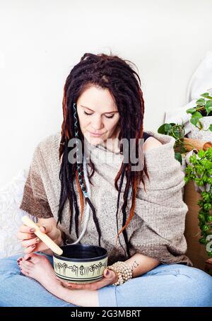daily meditation practice at home with singing bowl Stock Photo