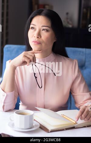 Beautiful young woman making notes Stock Photo