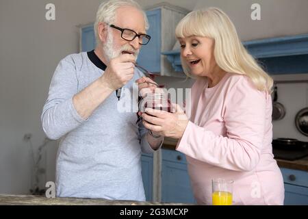 Elderly couple cooking in kitchen. Stock Photo