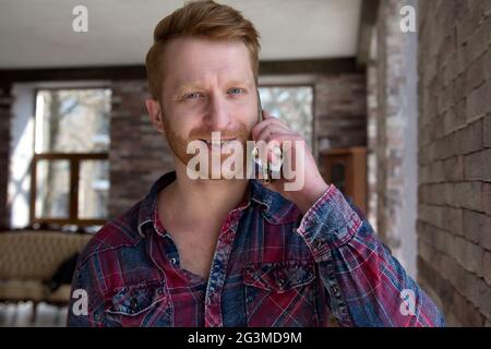 Handsome young man talking on phone. Stock Photo
