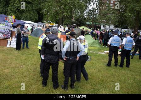 London, UK. 17th June, 2021. Police and enforcement officers try to evict a group of people who have set up a camp on Shepherd's Bush Green. Credit: Mark Thomas/Alamy Live News Stock Photo