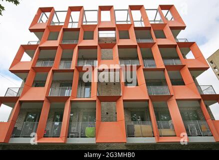 Distictive, orange, glass-reinforced cement (GRC) panels on a newly built block of Local Authority apartments in Hackney, London, UK Stock Photo