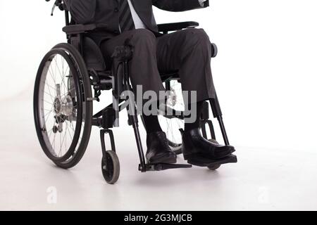 Disabled man in wheelchair in suit. Stock Photo