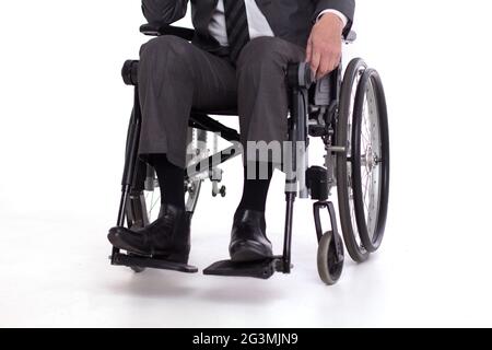 Disabled man in wheelchair in suit. Stock Photo