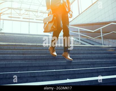 Cropped picture of businessman walking down stairs. Stock Photo