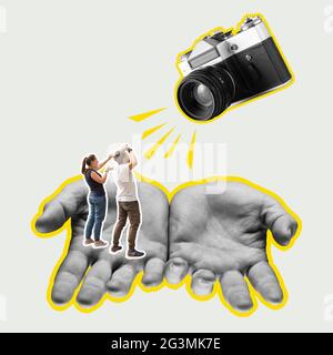 Focus on the male hands. Retro vintage camera and small people. Modern design. Stock Photo