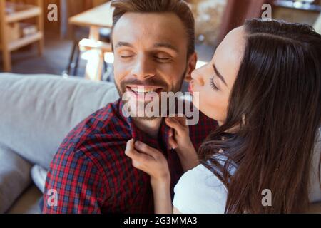 Happy couple sitting on couch. Stock Photo