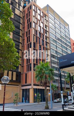 Close to the stonework of St Marys Cathedral, St James Church and Hyde Park Barracks is the new glass and stone facade King and Phillip Apartments. Stock Photo