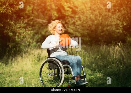 Wheelchair basketball player with ball on his lap Stock Photo