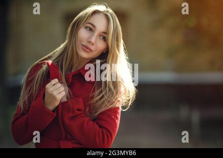Young woman walking wearing red coat Stock Photo