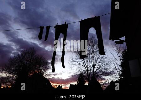 "03.04.2021, Briescht, Brandenburg, Germany - Silhouette: Laundry drying on a clothesline. 00S210403D630CAROEX.JPG [MODEL RELEASE: NO, PROPERTY RELEAS Stock Photo