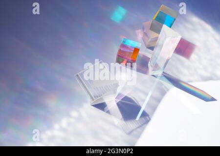 Abstract background with glass geometric figures prisms with light diffraction of spectrum colors and complex reflection. Stock Photo