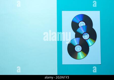 A lot of CDs on a blue background. Top view Stock Photo