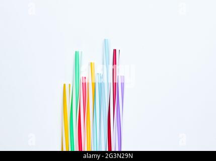 Lot of multi-colored cocktail tubes on white background. Top view Stock Photo