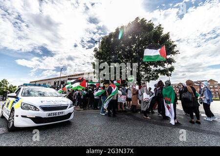 Manchester, UK. 16th June, 2021. Police Car Drives Past Protesters chanting and raising Palestinian flags during the protest.Protesters gather for a protest march from Hulme to The University of Manchester following the university sponsors' exchange of students from Israel and promoting the creation of weapons with Graphene. (Photo by Ryan Jenkinson/SOPA Images/Sipa USA) Credit: Sipa USA/Alamy Live News Stock Photo