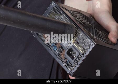 Cleaning the computer power supply from dust with a brush. Stock Photo
