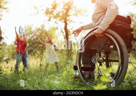 Close-up view on the wheels of a wheelchair. Bright Stock Photo