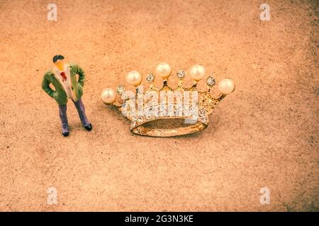 Figurine and Golden color crown model with fake pearls