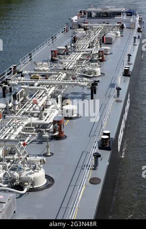 Inland vessel seen from above with pipelines on the deck for industrial transport of oil and gas on the river Mass in Maastricht, the Netherlands Stock Photo