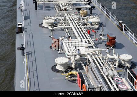 Inland vessel seen from above with pipelines on the deck for industrial transport of oil and gas on the river Maas in Maastricht Stock Photo