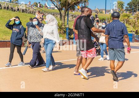 Families enjoying a day out a Barry Island Beach resort, South Wales, UK Stock Photo