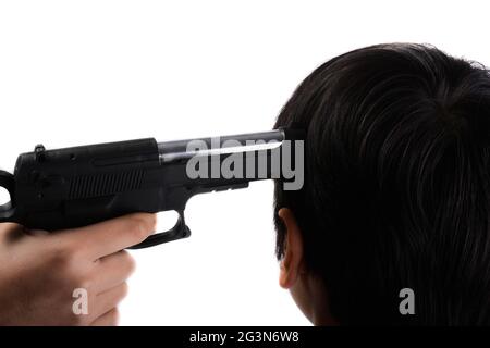 Gun in hand pointing to head Stock Photo