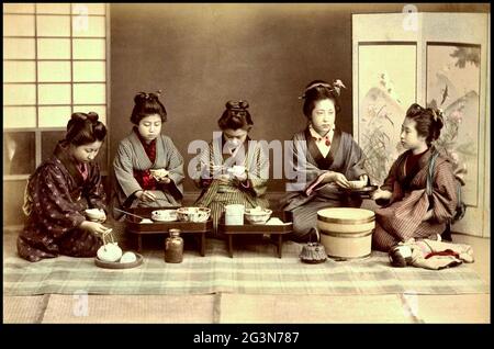 Vintage Kusakabe Kimbei photograph from Old Japan - A group of Japanese women eat their dinner - Eating Dinner. Stock Photo