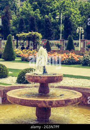 Water gushing off the fountain in the garden Stock Photo