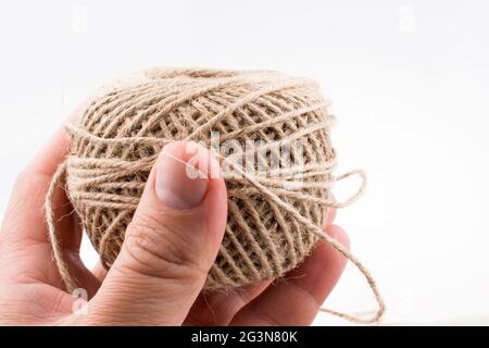 Spools of thread in hand isolated on a white background Stock Photo - Alamy