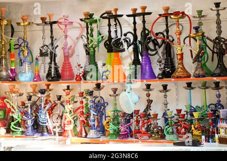 Group of eastern hookahs of various colors on a shelf Stock Photo