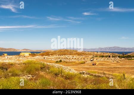 Landscape of Delos Island in Greece - view from the hill on the island with crystal blue sky and big area of ancient ruins. Stock Photo