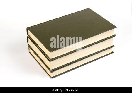 Three Green hardcover books on a white background. Stack of closed books. Side view. Selective focus. Stock Photo