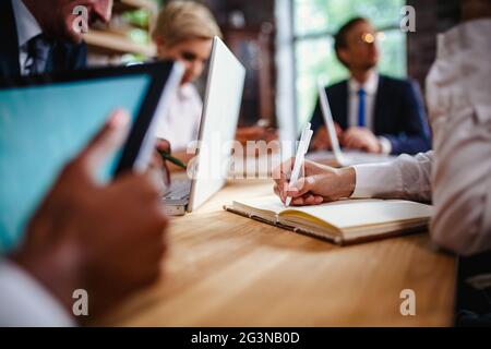 Selective focus on woman hand writing in notebook Stock Photo