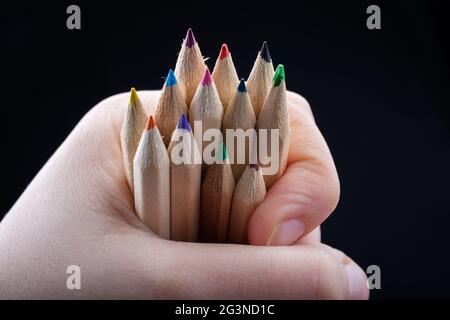 Hand holding colored pencils for creative idea and concept. Stock Photo