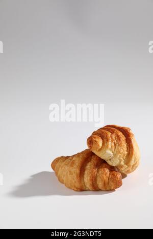 Croissant isolated in  wihite background with sunny light Stock Photo