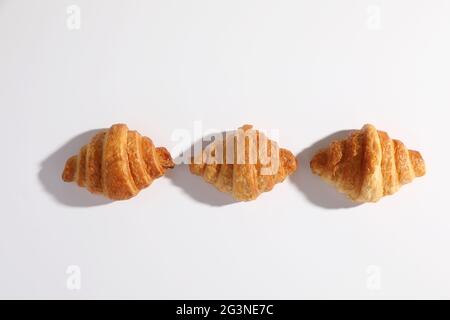 Croissant isolated in  wihite background with sunny light Stock Photo