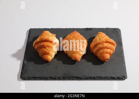 Croissant isolated in  wihite background with sunny light Stock Photo