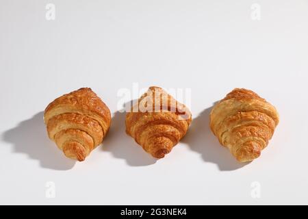 Croissant isolated in  wihite background with sunny light Stock Photo