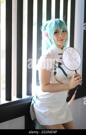 Japan anime cosplay portrait of a girl with chinese dress costume in  chinese garden Stock Photo - Alamy