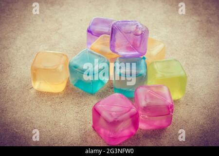 Fake colorful ice cubes  on wood Stock Photo