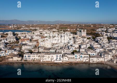 Paros island, Greece, Cyclades. Naoussa cityscape aerial drone view. Naousa waterfront white buildings blue windows, Cycladic architecture. calm sea w Stock Photo