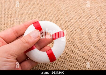 Life preserver in hand on canvas Stock Photo