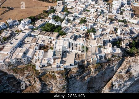 Folegandros island, Greece, Cyclades. Chora village aerial drone view. Traditional Cycladic architecture, whitewashed buildings on top of steep cliffs Stock Photo