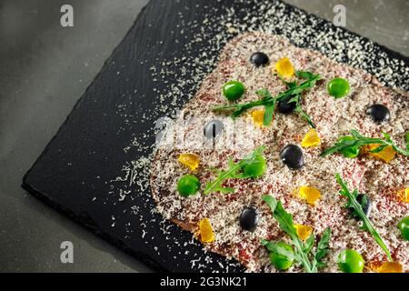 Veal carpaccio with dried yolk and parmesan Stock Photo