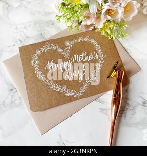 Happy Mother's Day Card on Kraft Paper with white ink and pointed pen with envelope Stock Photo