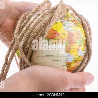 Earth globe wrapped with rope Stock Photo - Alamy